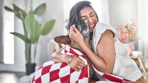 A girl hugging her dog